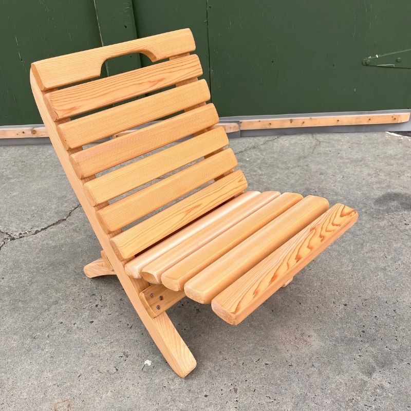 Camp Chair on a concrete surface with a green wall in the background