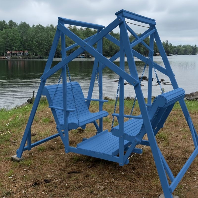 Blue Classic Garden Swing set by a lake with trees in the background