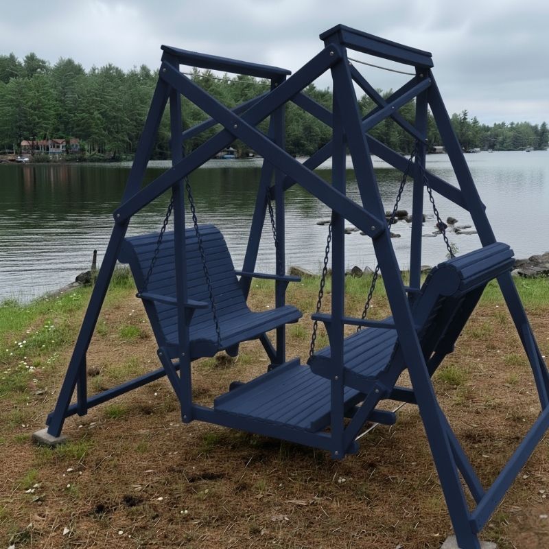 Patriot blue Classic Garden Swing set by a lake with trees in the background