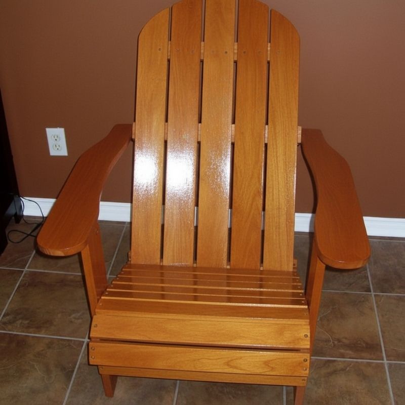 Wooden Adirondack chair on a patio with greenery in the background - flat  back  golden glossy - clear cedar
