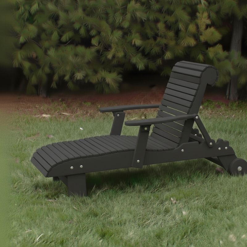Deluxe Lounge Chair on grass with green bushes in the background - poly luxe - dark grey