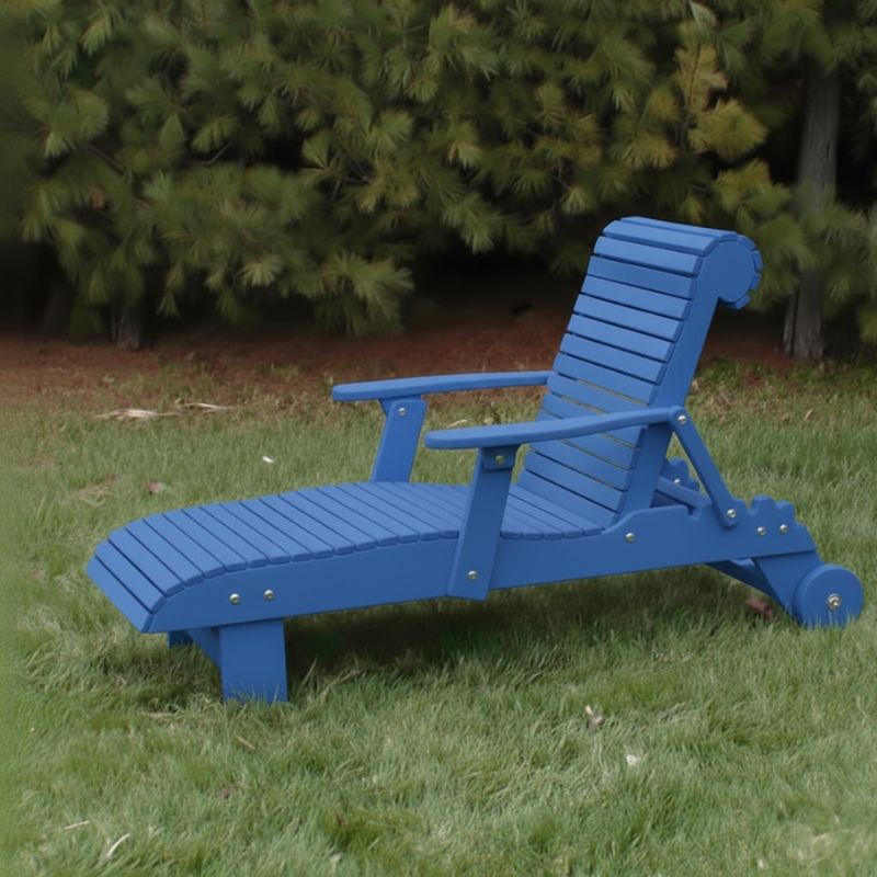 Deluxe Lounge Chair on grass with green bushes in the background - poly luxe - blue