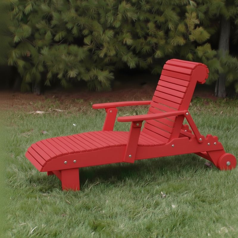 Deluxe Lounge Chair on grass with green bushes in the background - poly luxe - red