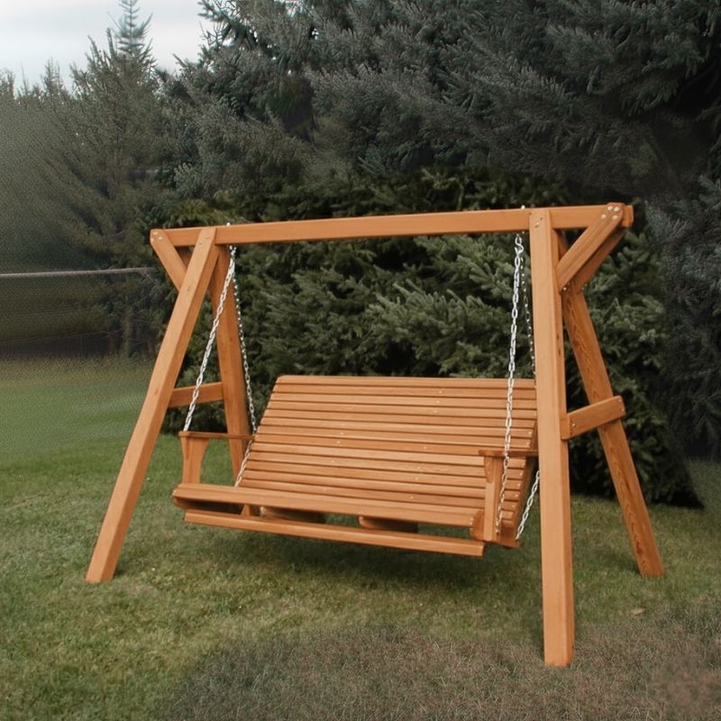 Cedar Family Porch Swing with Frame set with a bench seat in a grassy area with trees in the background