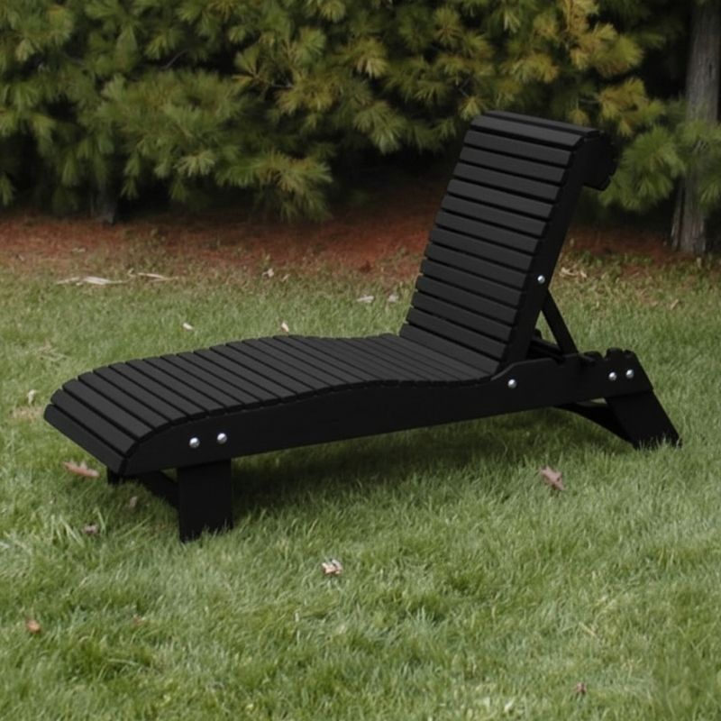 Lounge Chair on grass with trees in the background - poly luxe- black