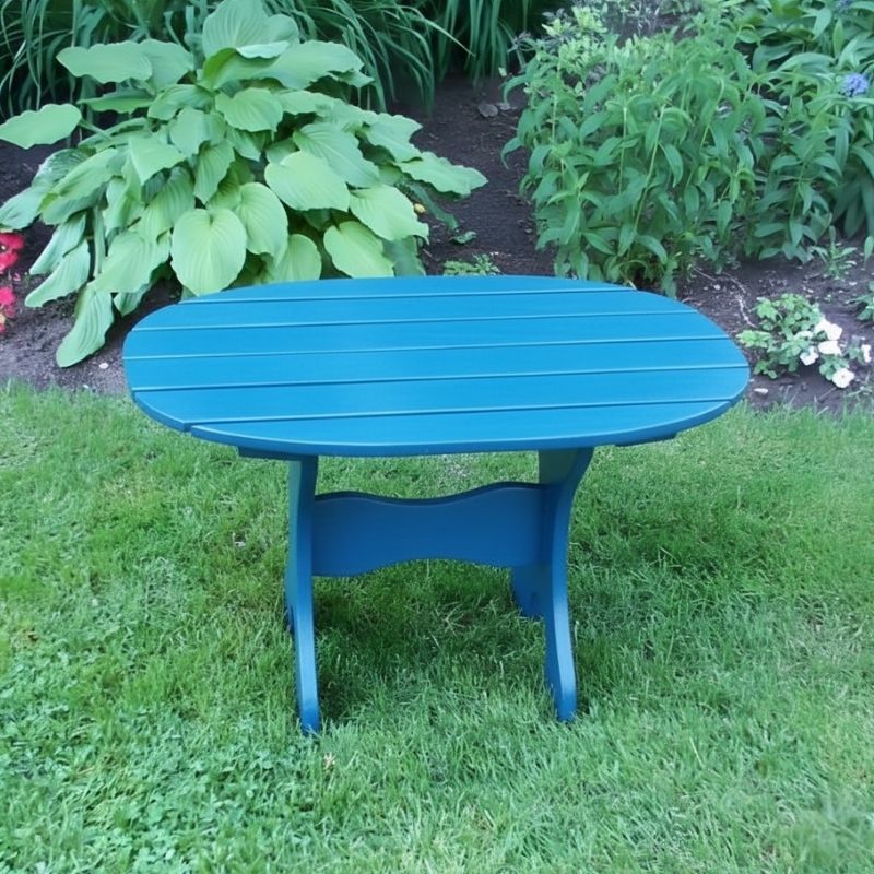 Oval Side Table in a grassy area with plants in the background - poly luxe - aruba blue