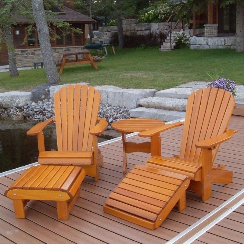 Royal Complete Patio Set on a wooden deck with a garden and building in the background.