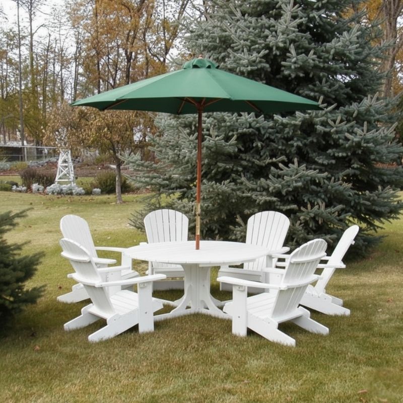 White Royal Picnic Set for 6 with a green umbrella on a grassy area with trees in the background.