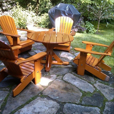 Wooden patio set with table and chairs on a stone patio