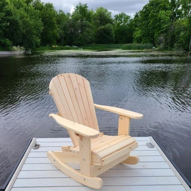 Royal Rocking Adirondack Chair (Large)  on a dock by a lake with trees in the background