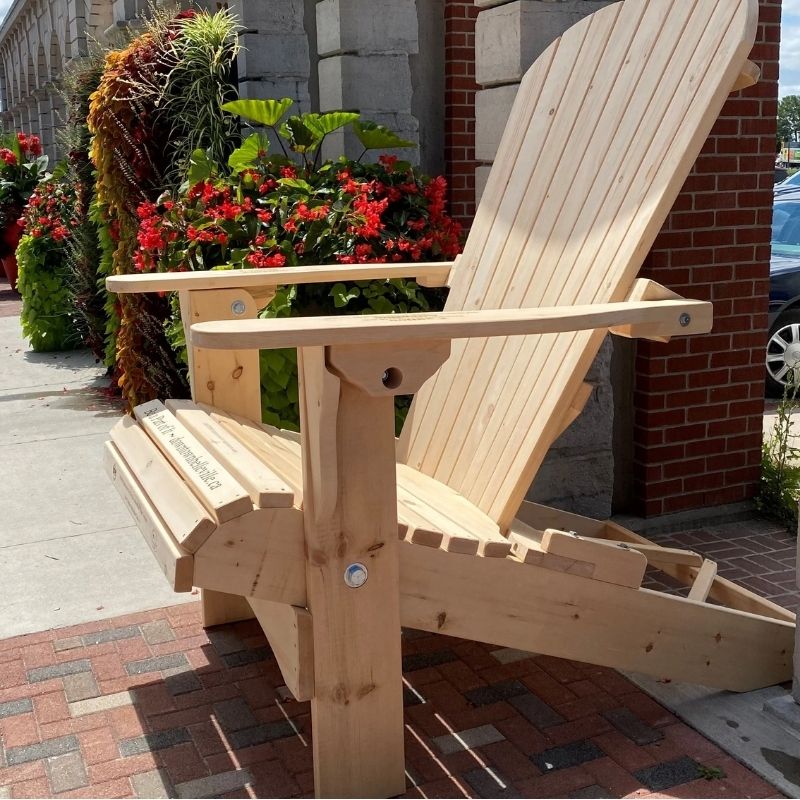 Traditional Giant chair on a patio with flowers and a building in the background