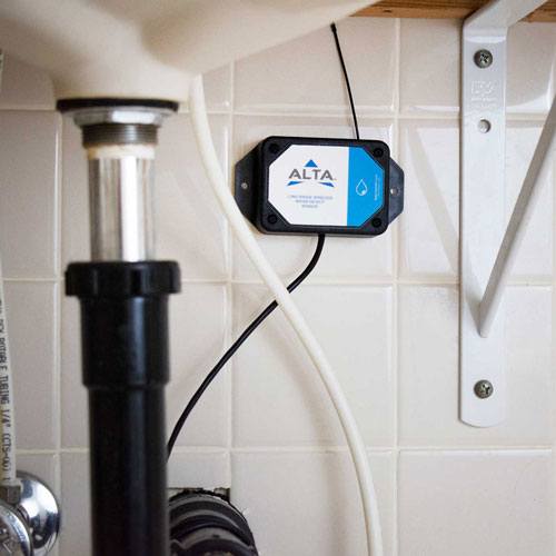 Monnit water detection sensor installed in a bathroom to protect a short-term rental property