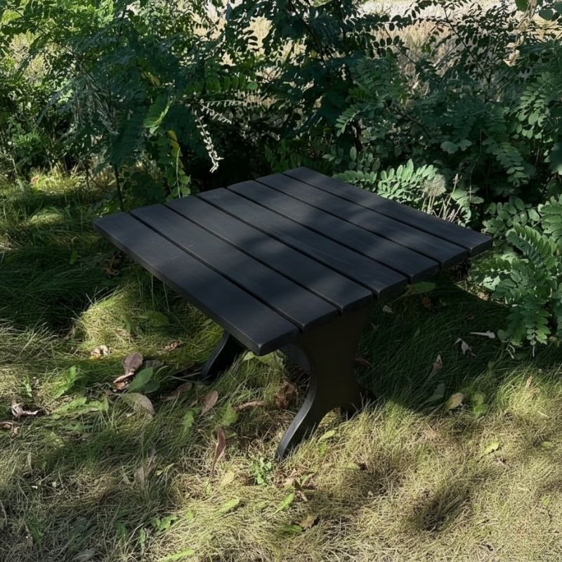 24" Square Side Table in a natural outdoor setting with greenery - clear cedar - golden glossy in a natural setting with greenery - poly luxe - black