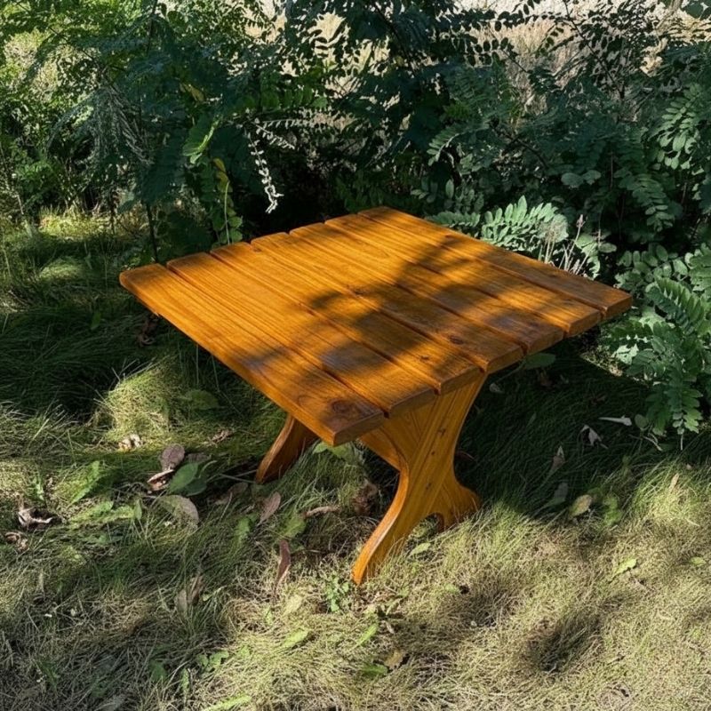 24" Square Side Table in a natural outdoor setting with greenery - knotted cedar - golden glossy