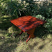 24" Square Side Table in a natural outdoor setting with greenery - knotted cedar - mahogany glossy