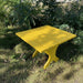 24" Square Side Table in a natural outdoor setting with greenery - clear cedar - golden glossy in a natural setting with greenery - poly luxe - lemon yellow