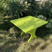 24" Square Side Table in a natural outdoor setting with greenery - clear cedar - golden glossy in a natural setting with greenery - poly luxe - lime green