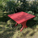 24" Square Side Table in a natural outdoor setting with greenery - clear cedar - golden glossy in a natural setting with greenery - poly luxe - red