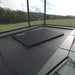 The Acon Crash Mat laying on top of a rectangular trampoline jumping surface