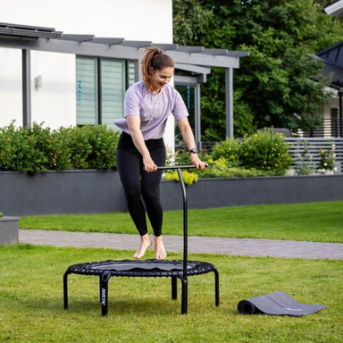 ACON Fit 1.41m Hexagon Rebounder Black Fitness Trampoline with Handlebar - Woman Bouncing OUtdoor Set Up