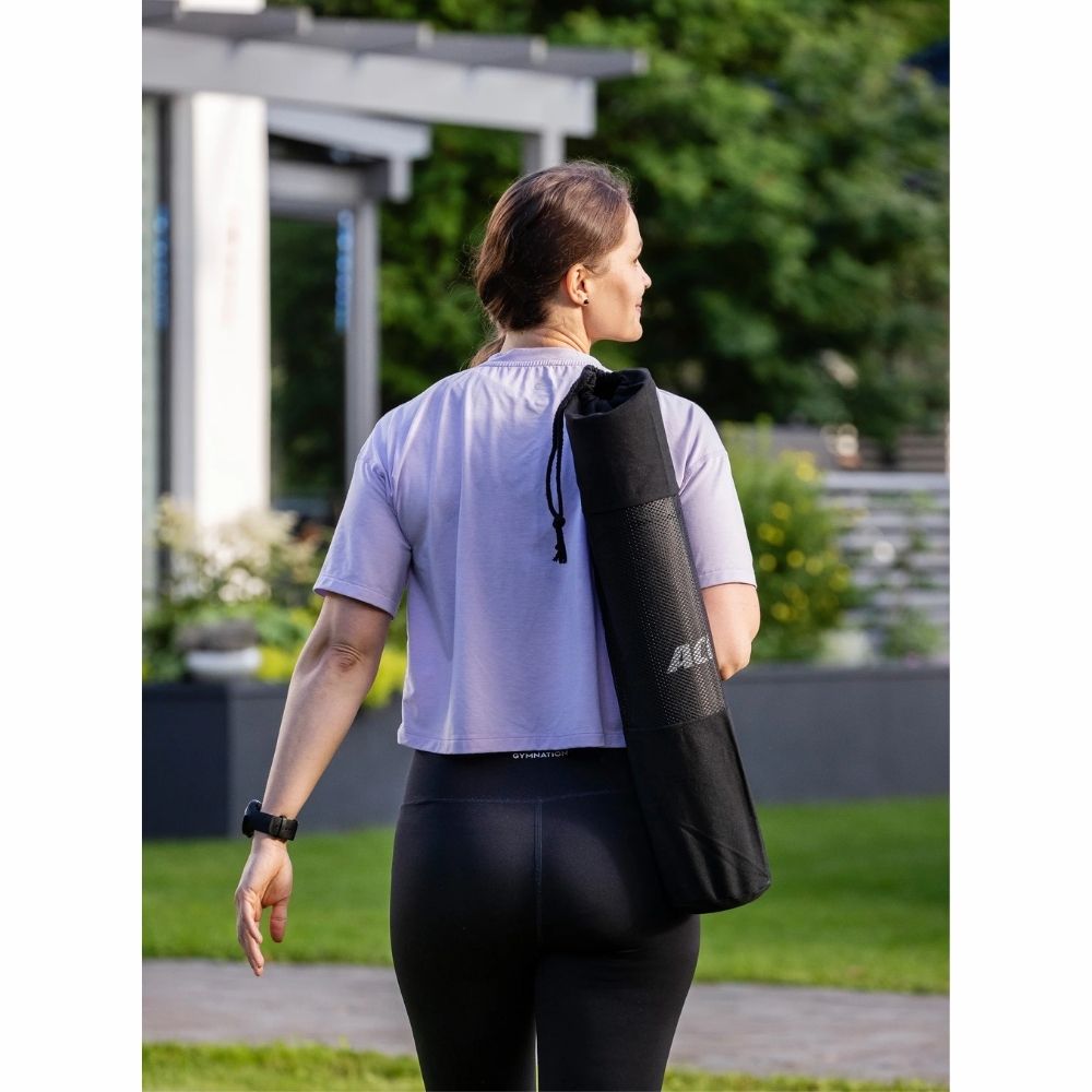 Image of Acon Eco-friendly Yoga Mat rolled up with cross chest-strap.