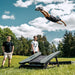 ACON Freestyle Mini Trampoline - Man performing a flip off a trampoline in an outdoor setting with trees and blue sky.