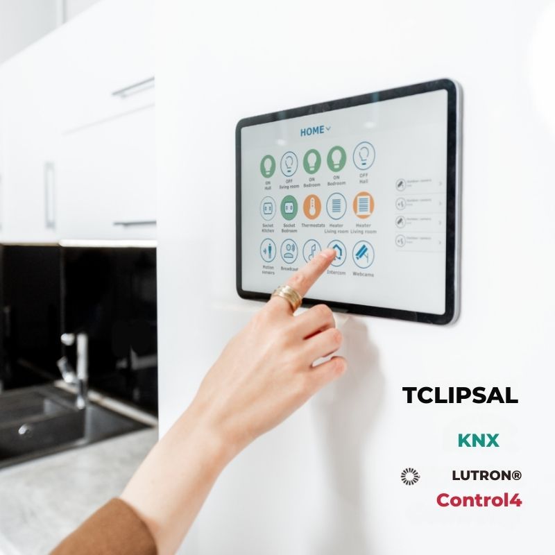 Person interacting with a smart home control panel in a kitchen.