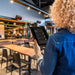Person using the app through the tablet in a modern restaurant setting