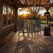 Outdoor setting of Dark Grey Bistro Set Comfort Bundle on a deck during sunset.