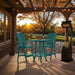 Outdoor setting of Aruba Blue Bistro Set Comfort Bundle on a deck during sunset.