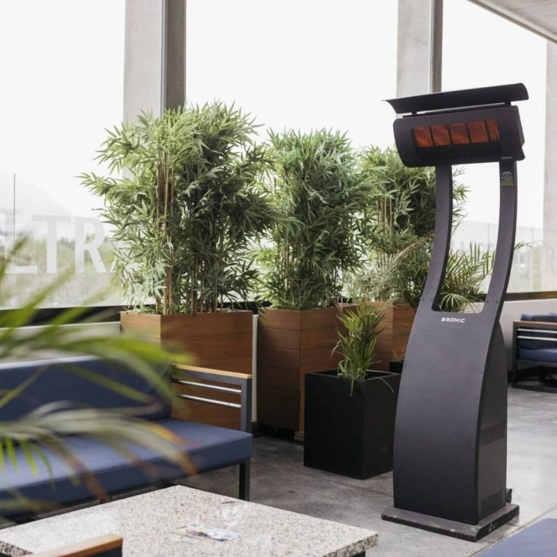 Outdoor patio heater on a patio with plants and furniture