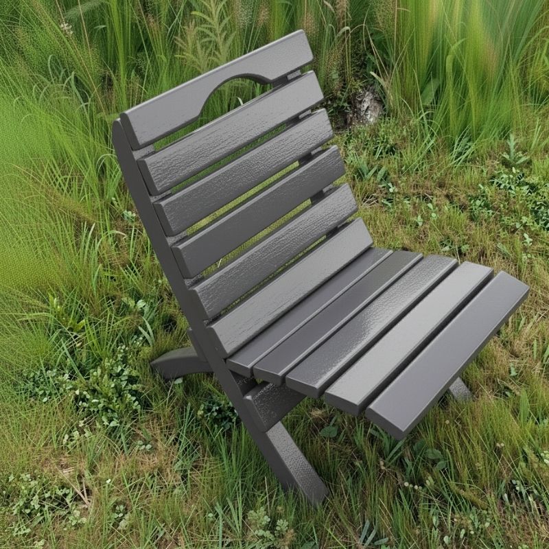 Camp Chair in a grassy outdoor setting - poly luxe - dark grey