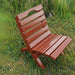 Camp Chair in a grassy outdoor setting clear cedar - mahogany glossy