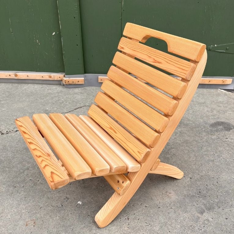 Camp Chair on a concrete surface with a green wall in the background
