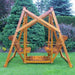 Classic graden swing set with two seats on a grassy area with trees in the background