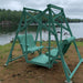 Aruba blue Classic Garden Swing set by a lake with trees in the background