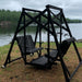Black Classic Garden Swing with two seats by a lake on a cloudy day