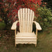 Wooden Adirondack chair on a patio with greenery in the background -sandal back