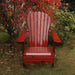 Wooden Adirondack chair on a patio with greenery in the background - sandal back  mahogany glossy - knotted cedar