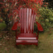 Wooden Adirondack chair on a patio with greenery in the background - sandal back  mahogamy glossy - clear cedar