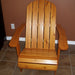 Wooden Adirondack chair on a patio with greenery in the background - flat back  golden glossy - knotted cedar