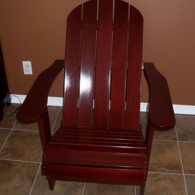 Wooden Adirondack chair on a patio with greenery in the background - flat back  mahogamy glossy - clear cedar