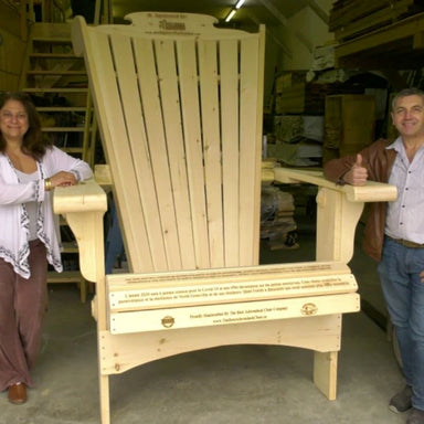 Two people standing next to Customized Giant in a warehouse setting.