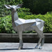 Deer II Geometric Steel Outdoor Sculpture - Outdoor set up with bush and trees on the background