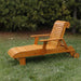 Deluxe Lounge Chair on grass with trees in the background - knotted cedar - golden glossy