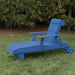 Deluxe Lounge Chair on grass with green bushes in the background - poly luxe - blue