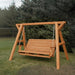 Cedar Family Porch Swing with Frame set with a bench seat in a grassy area with trees in the background