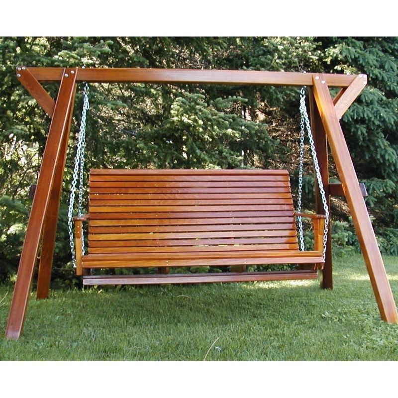 Wooden swing set with a bench seat in a garden setting