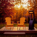 Orange Folding Muskoka Portable Comfort Bundle in a patio during sunset.