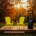 Yellow Adirondack chairs on a wooden deck with a heater in the evening.